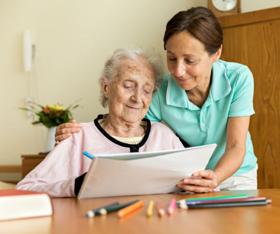 elderly woman doing occupational therapy with another woman